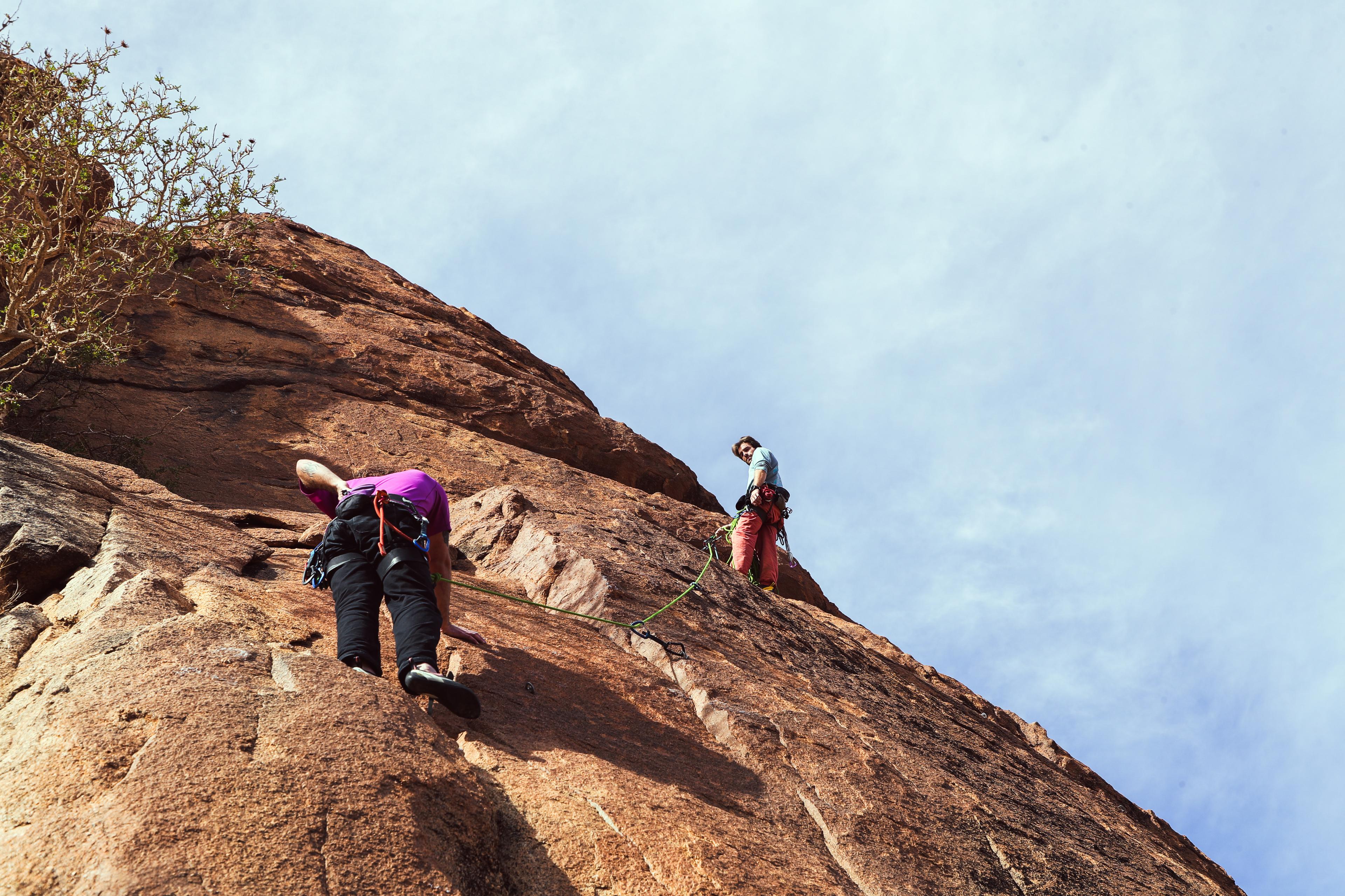 Climbers on a red rock face — the roots of 603 Printing